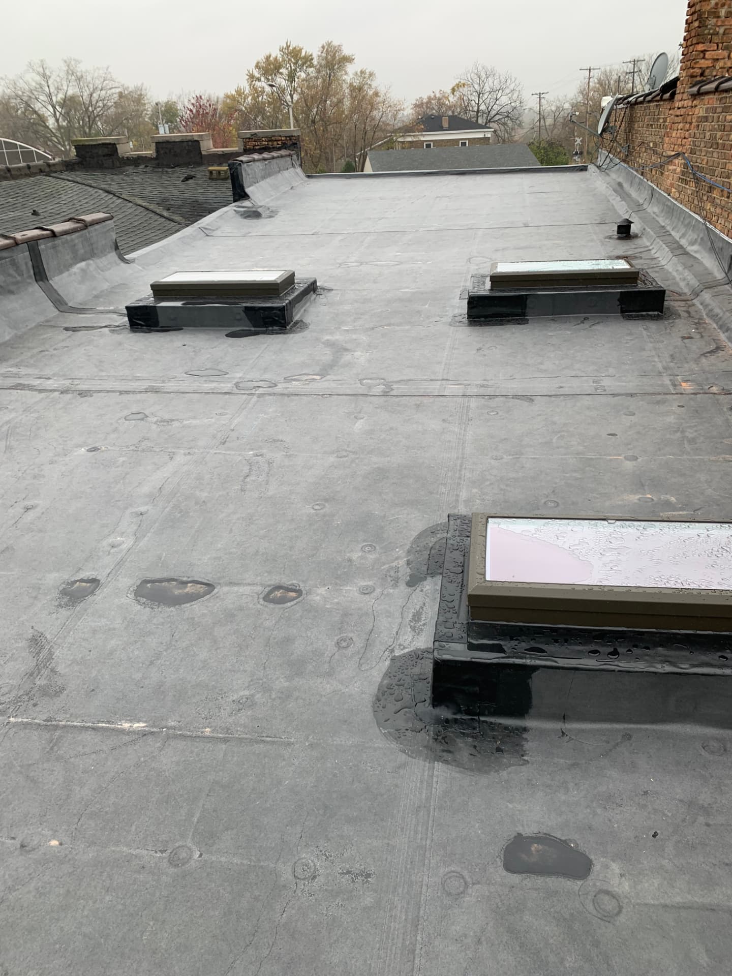 New EPDM flat rubber roof with three skylights